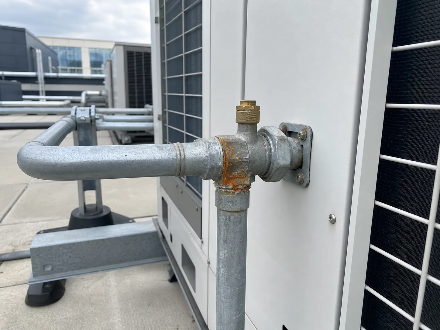 Wide rooftop view of a corroded HVAC connection